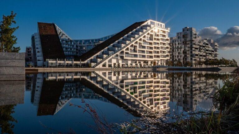 בניין 8 House ב-Ørestad משתקף במים בשעת בין ערביים